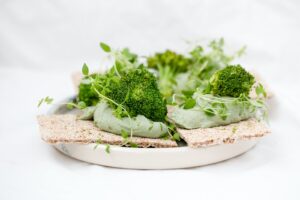 green vegetable on brown wooden round plate